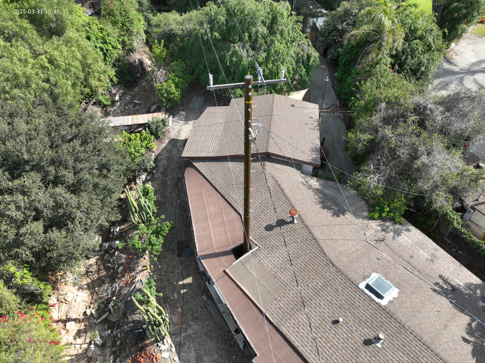 Elevated visual view of a distribution pole near a residence